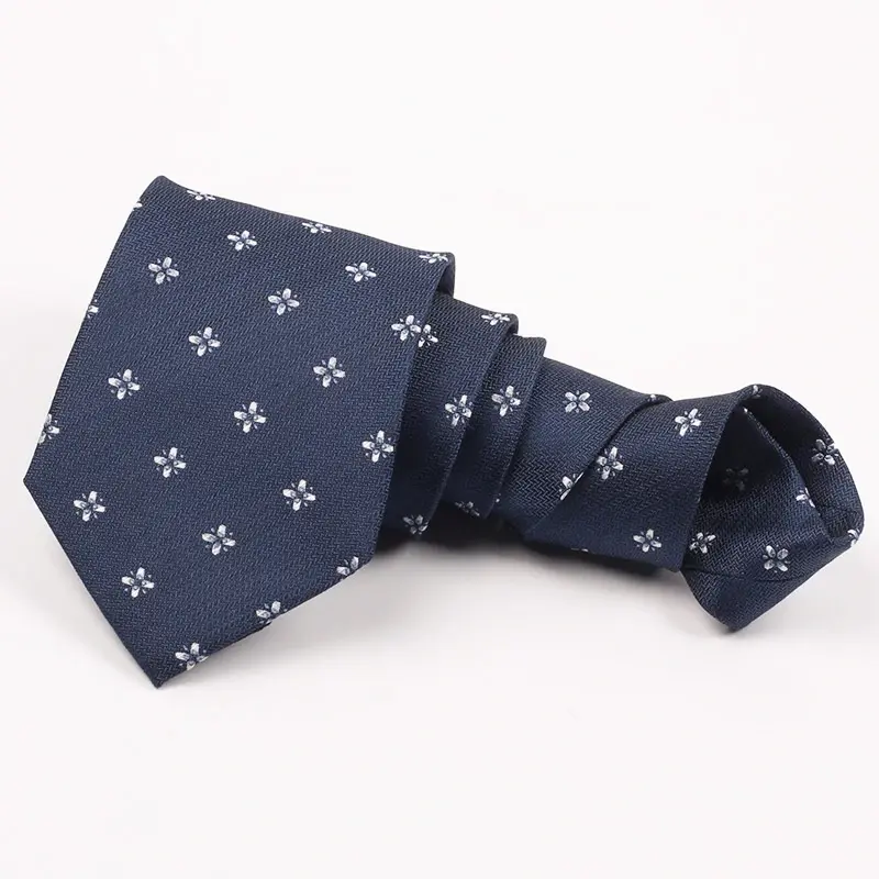 Knotted navy tie with small repeated pale decorative motifs.