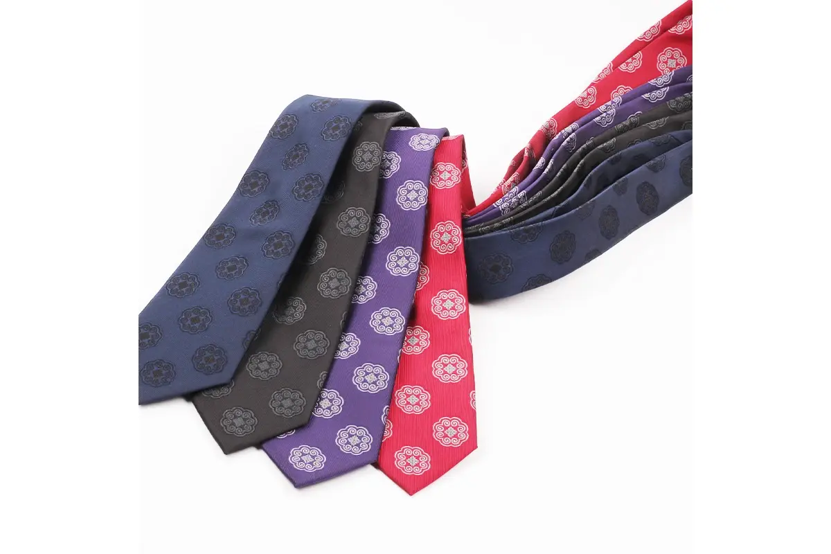 Navy, black, purple and red ties with repeated circular emblems.