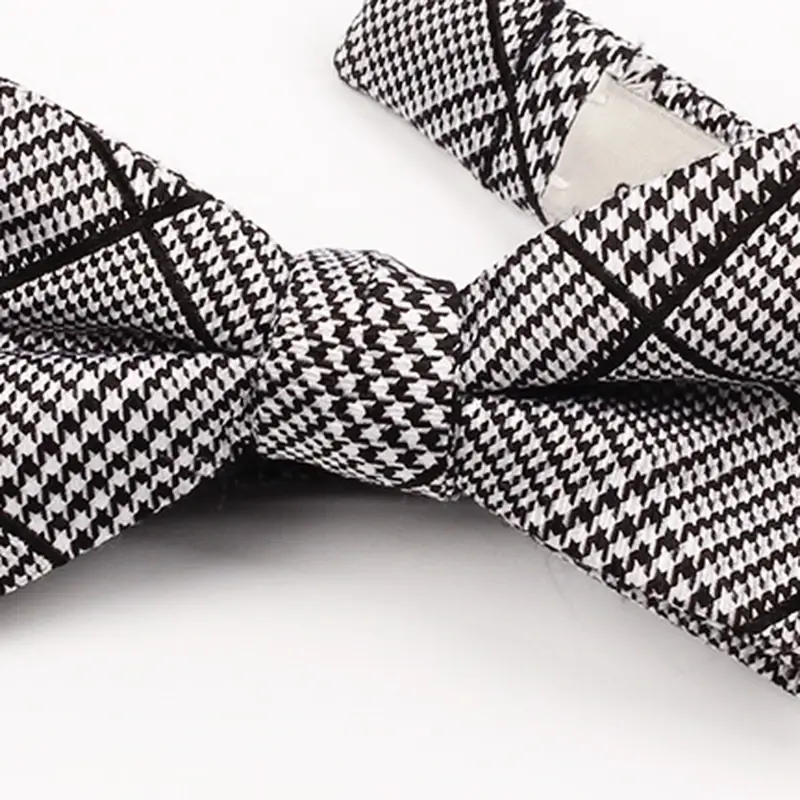 Close-up of black and white checked bow tie