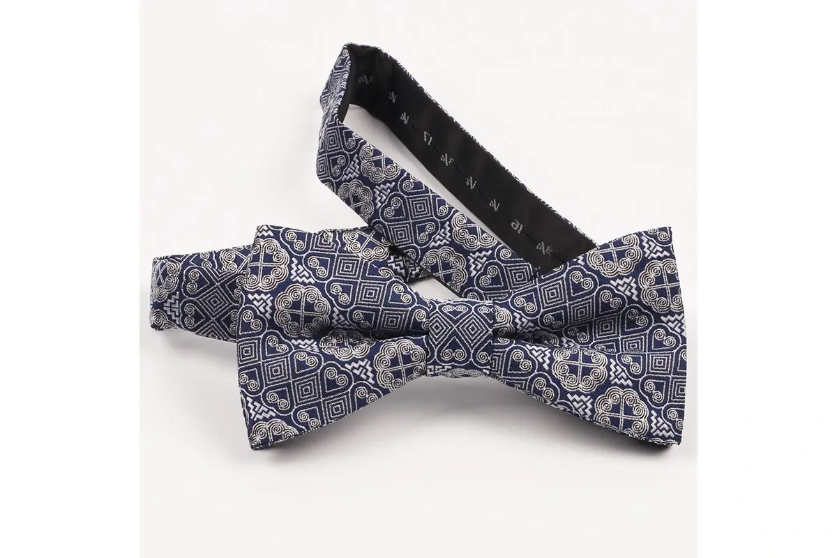 Gray and blue pre-tied bow tie with a dense geometric woven motif.