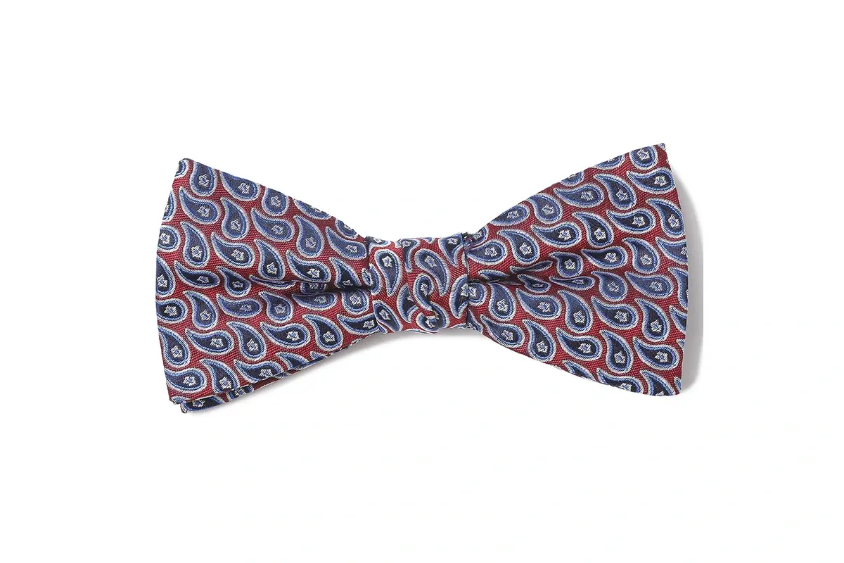 Pre-tied bow tie with a repeating red, blue and white paisley pattern.