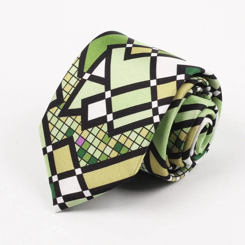 Rolled green tie with bold black and white geometric artwork.