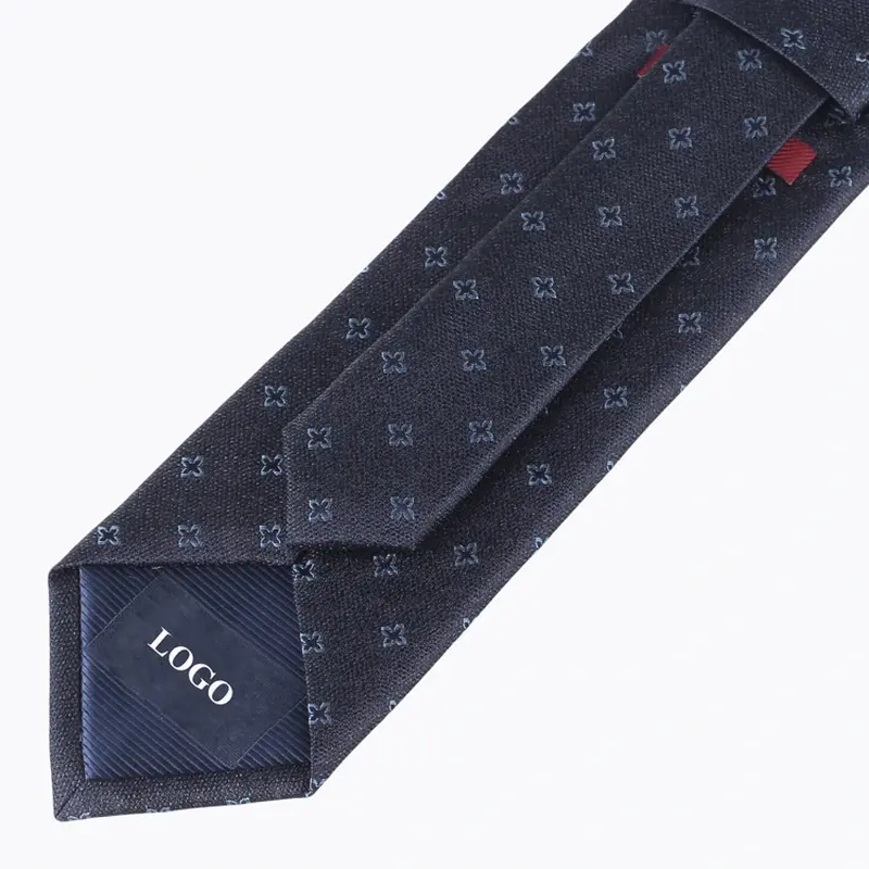 Navy patterned tie reverse with a center seam and sample mark on the tipping.