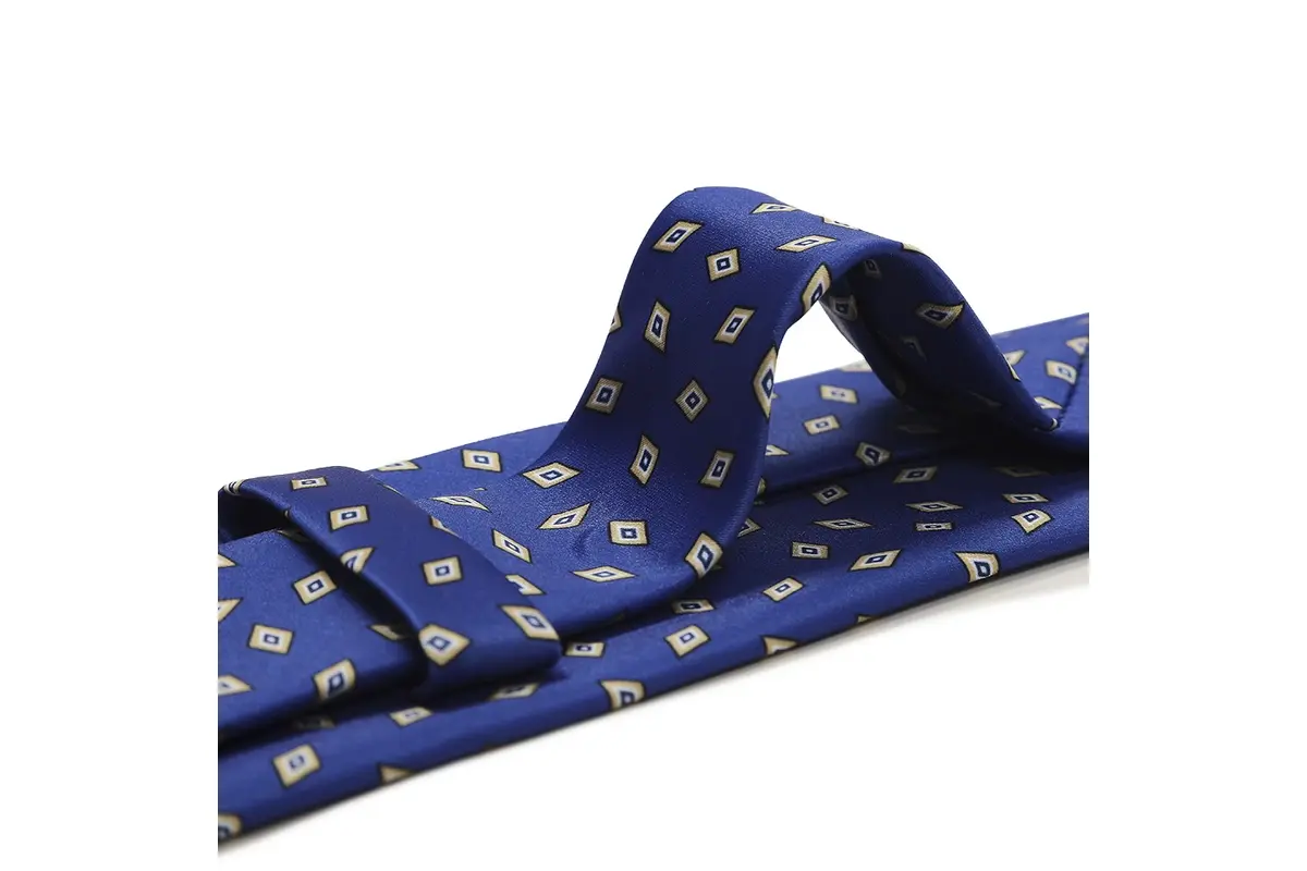 Blue tie with small repeated yellow diamond motifs visible across a raised fold.