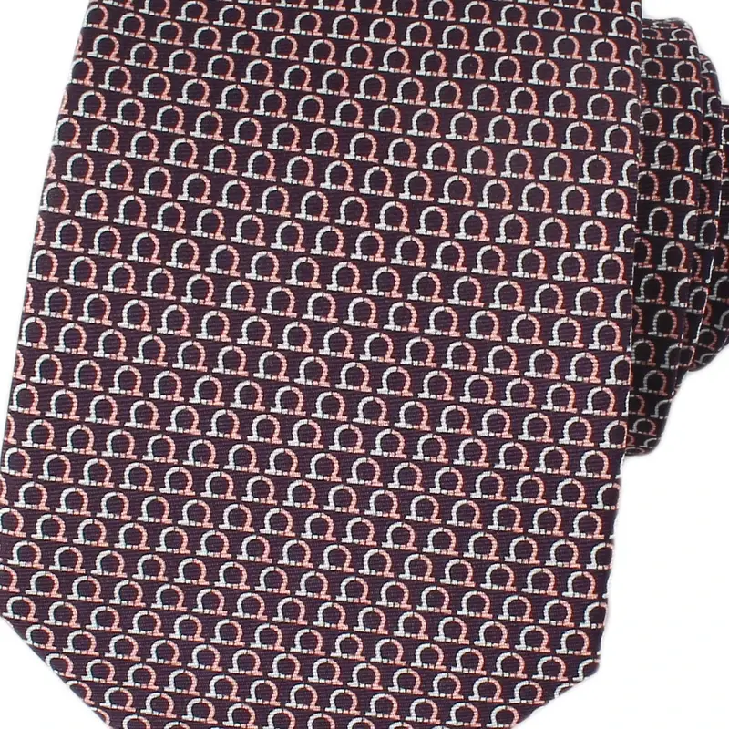 Close-up of burgundy necktie with a fine repeating pattern