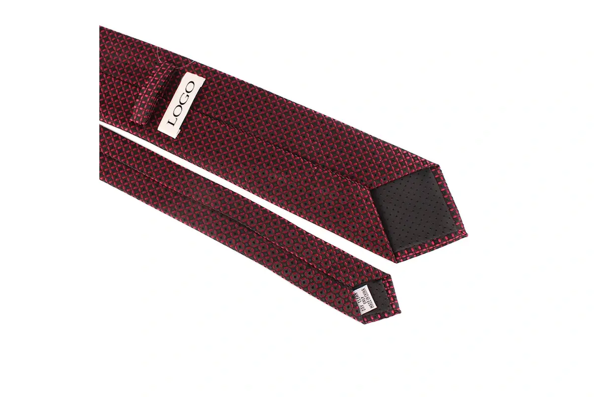 Red and black patterned tie reverse with a center seam, tipping and labels.