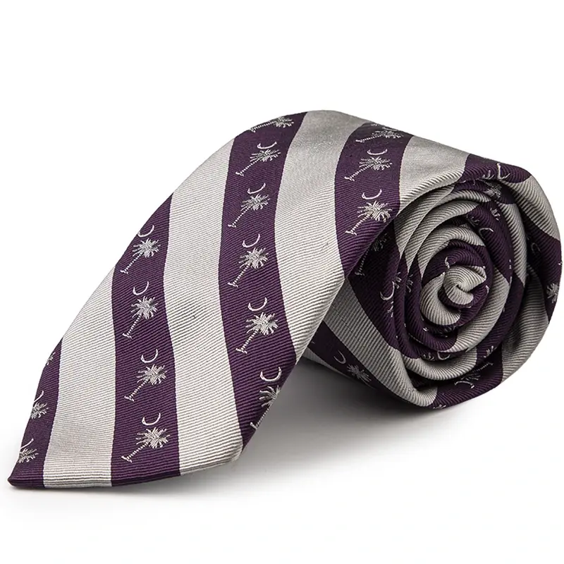 Rolled purple and ivory striped tie with palm and crescent motifs.
