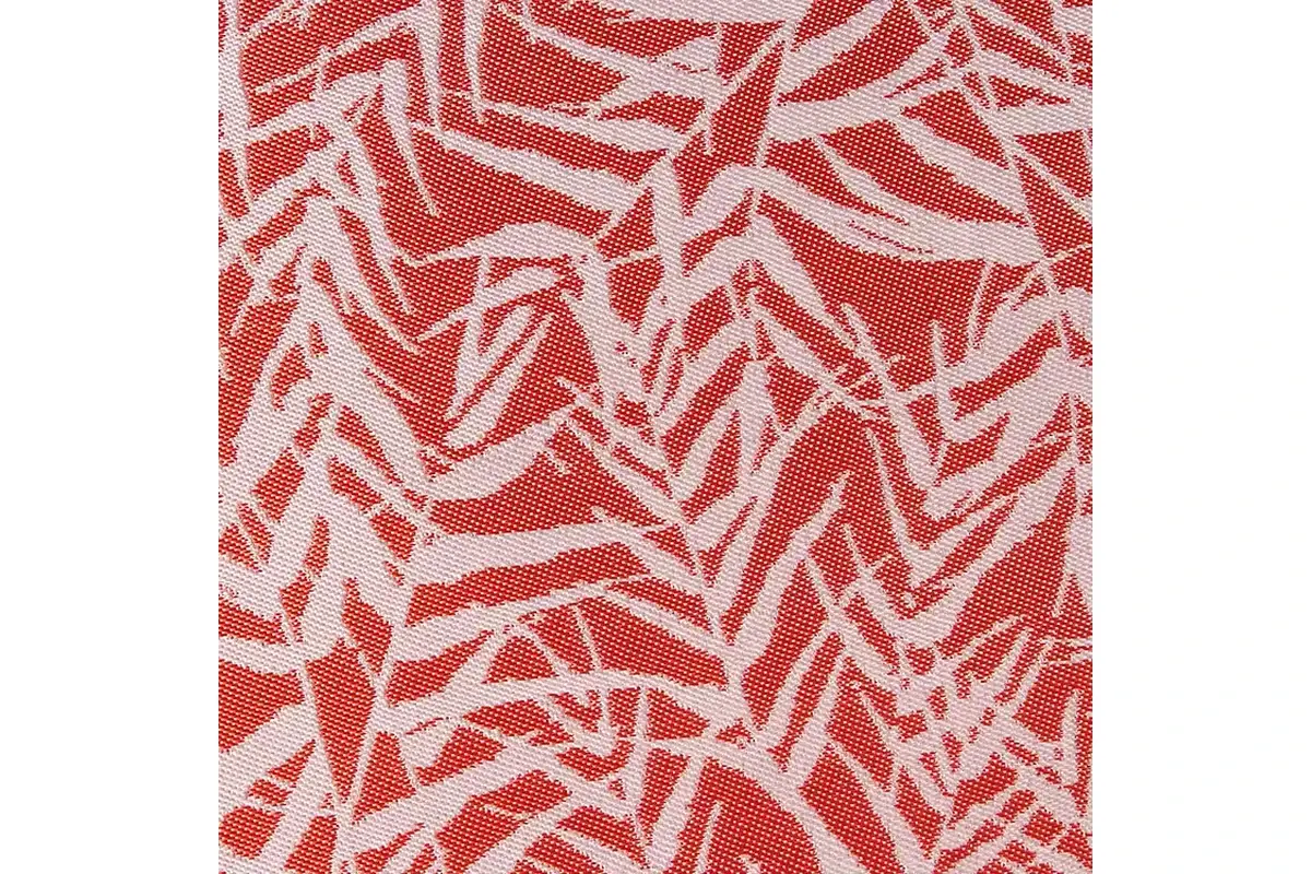 Close-up of a red and ivory woven leaf pattern showing the yarn structure.