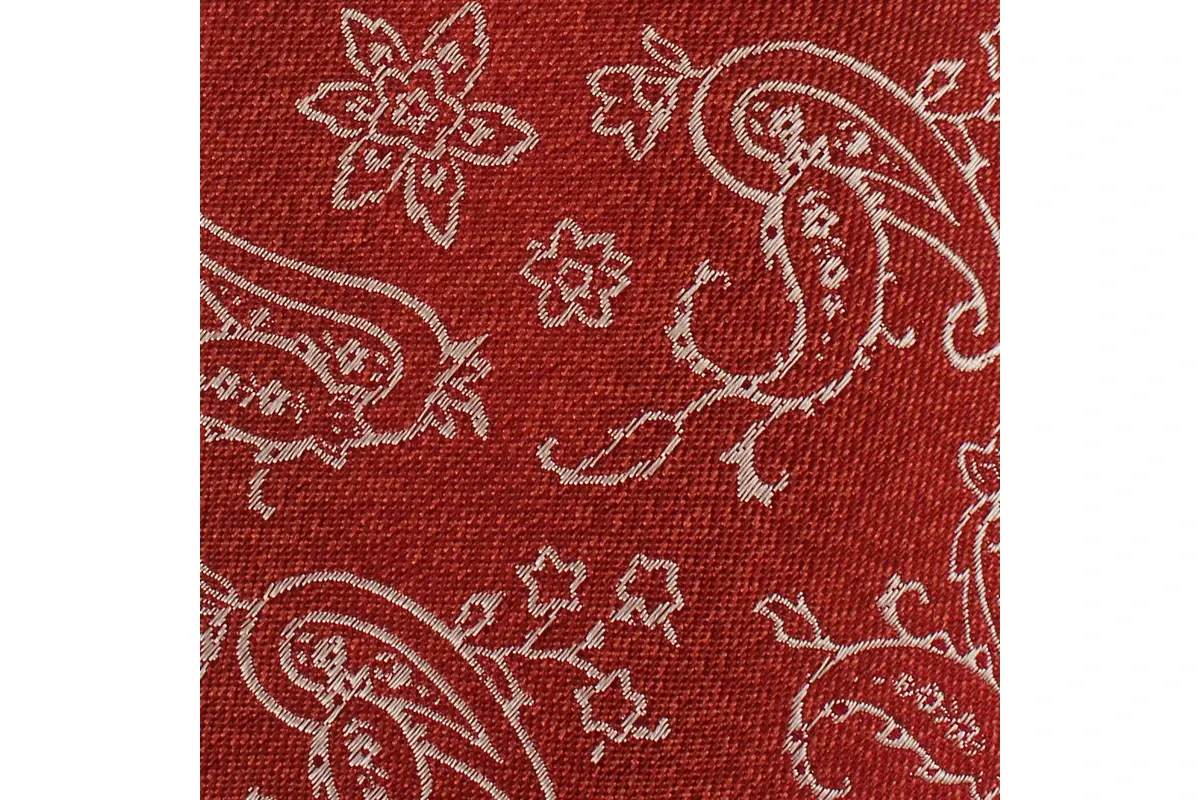 Ivory paisley and floral motifs woven into rust-red fabric.