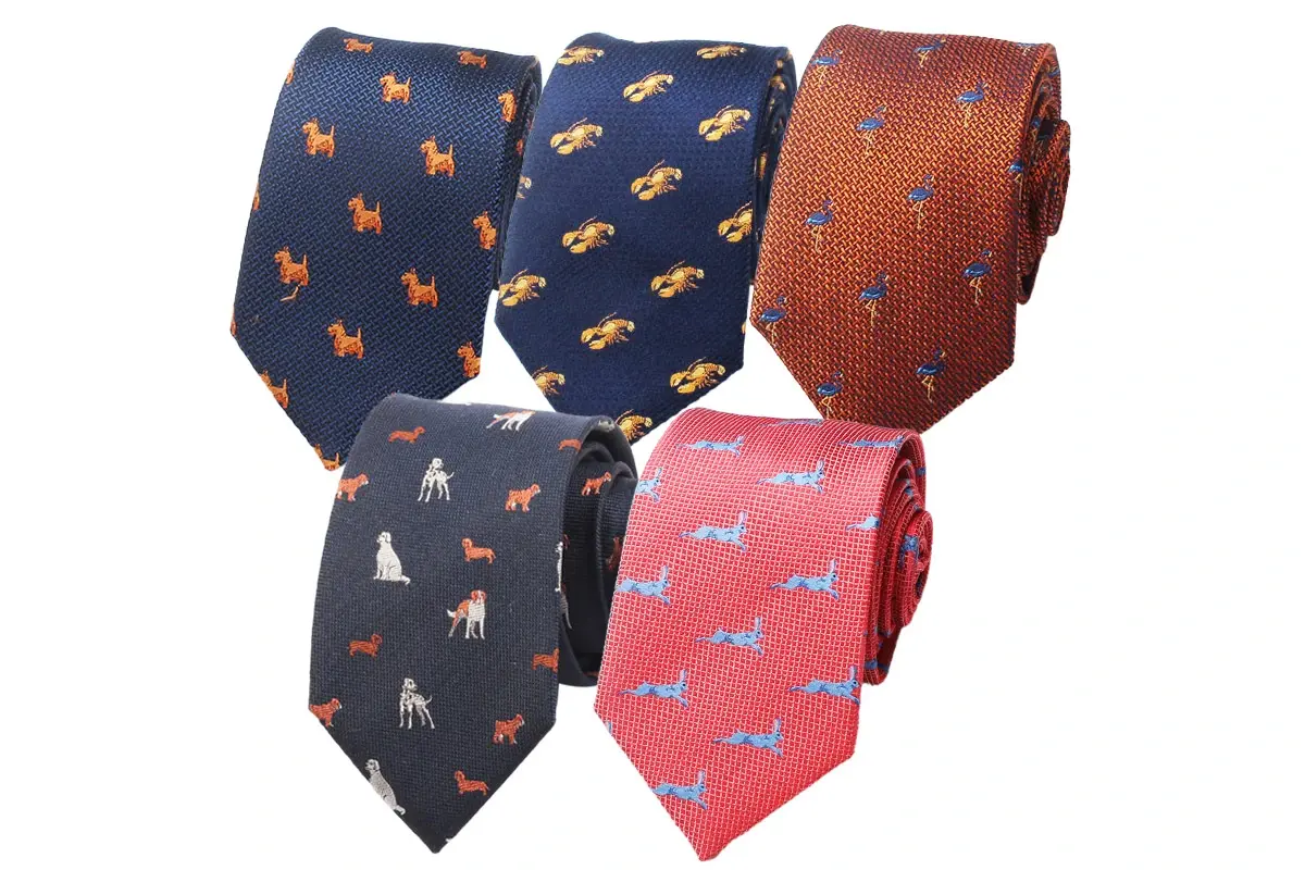 Five printed ties in navy, brown, black and coral colorways with small animal.
