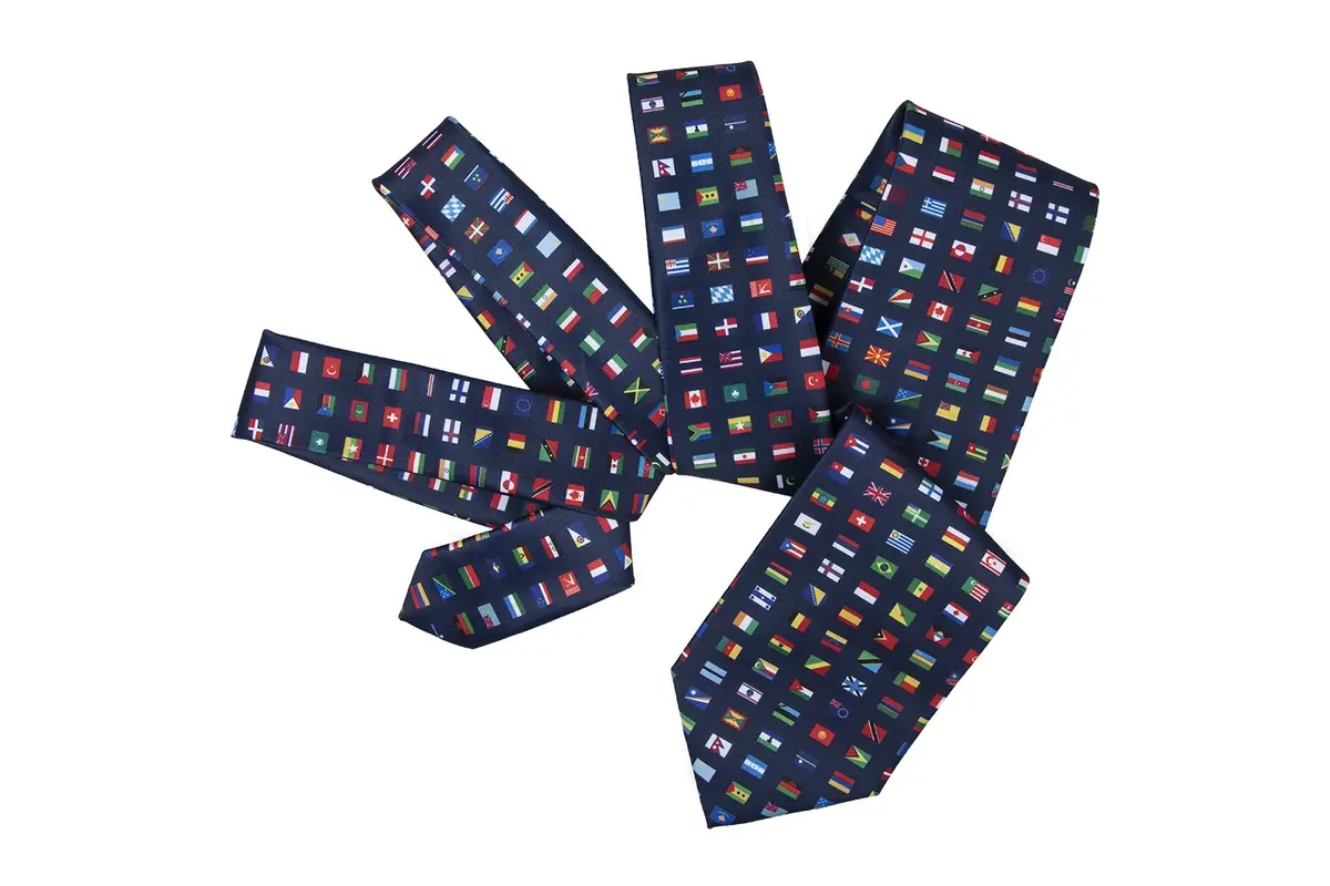 Five navy tie pieces with a repeated grid of small multicolor square motifs.