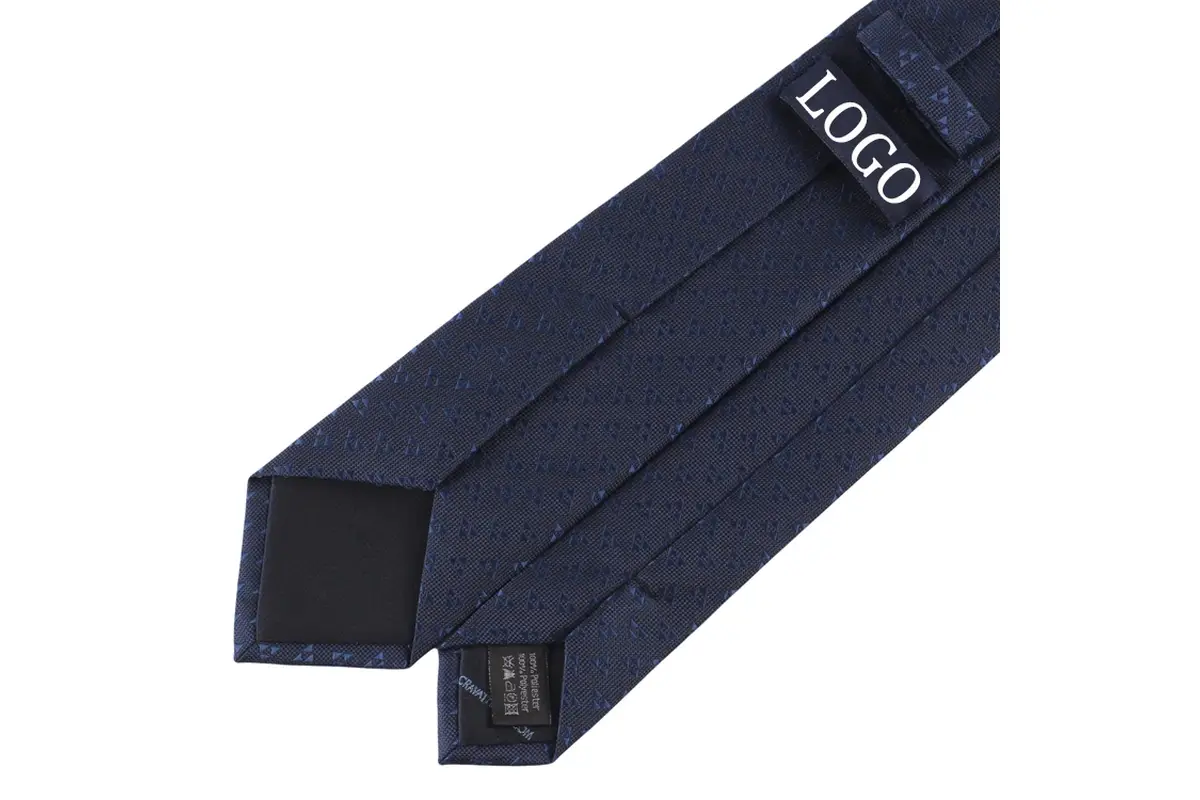 two navy patterned ties with folded tips, keeper loops and sample label.