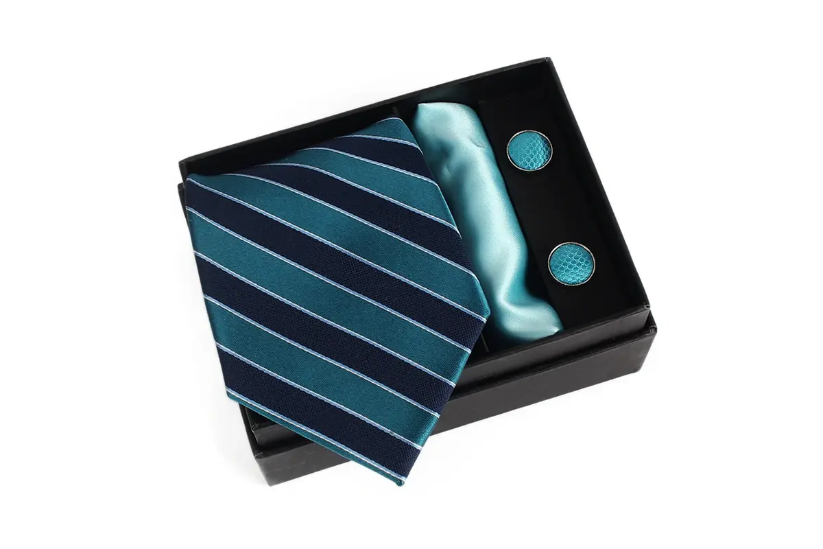 Black gift box with a teal striped tie, pocket square and cufflinks.
