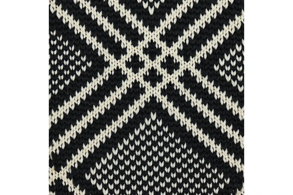 black and white woven fabric with a large centered geometric repeat.