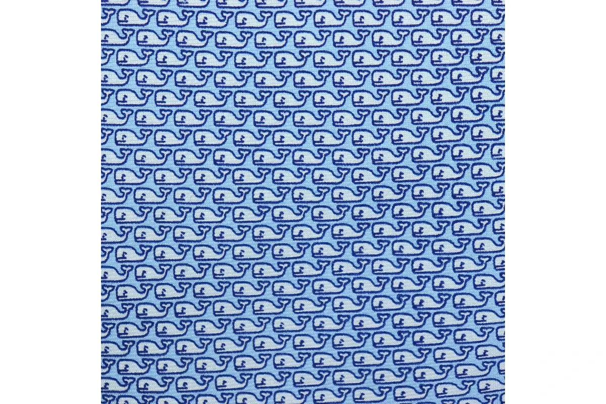 Blue and white fabric with a small geometric repeat aligned in regular rows.