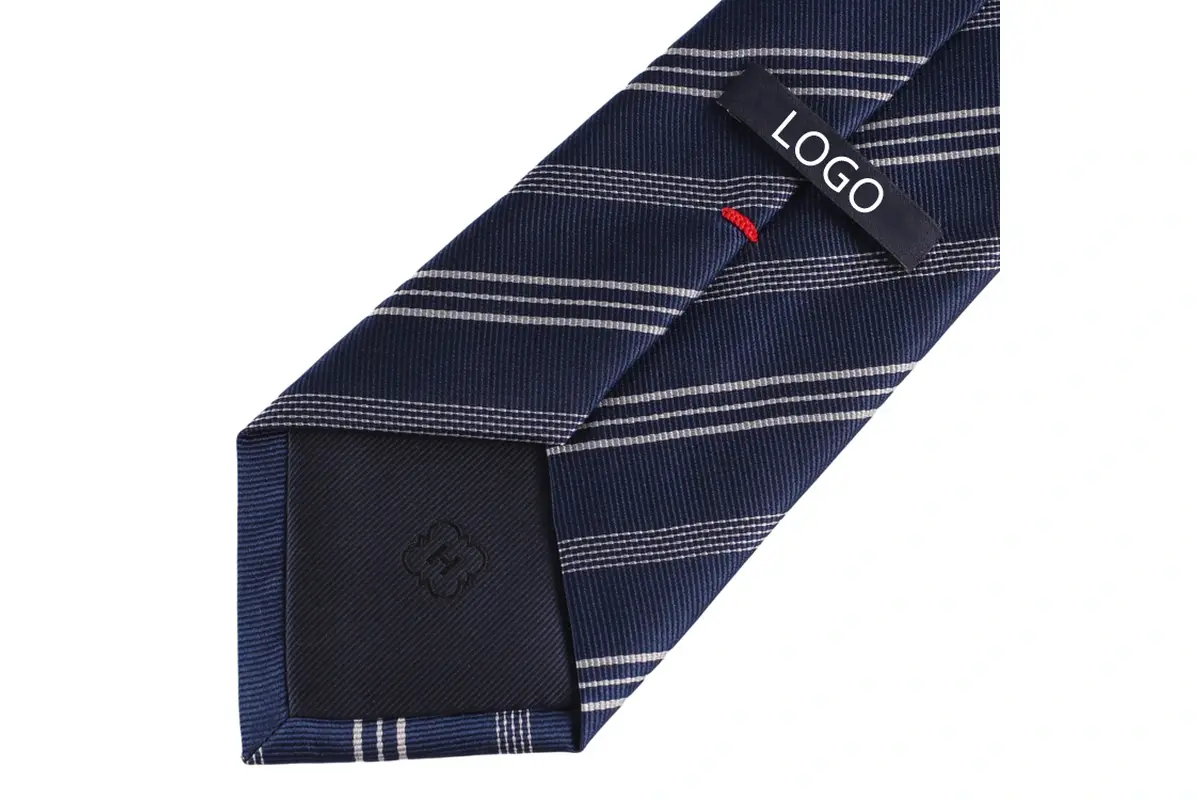A navy striped tie with a black sample label and red stitch marker.