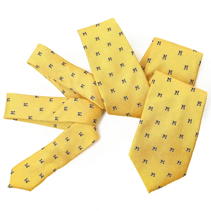 Five yellow tie pieces with a repeated small dark letter motif.