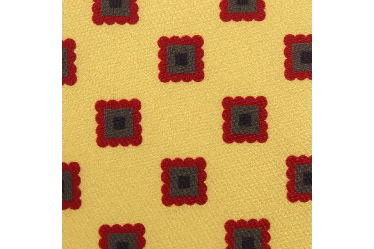 Yellow woven fabric with evenly spaced red and dark square motifs.